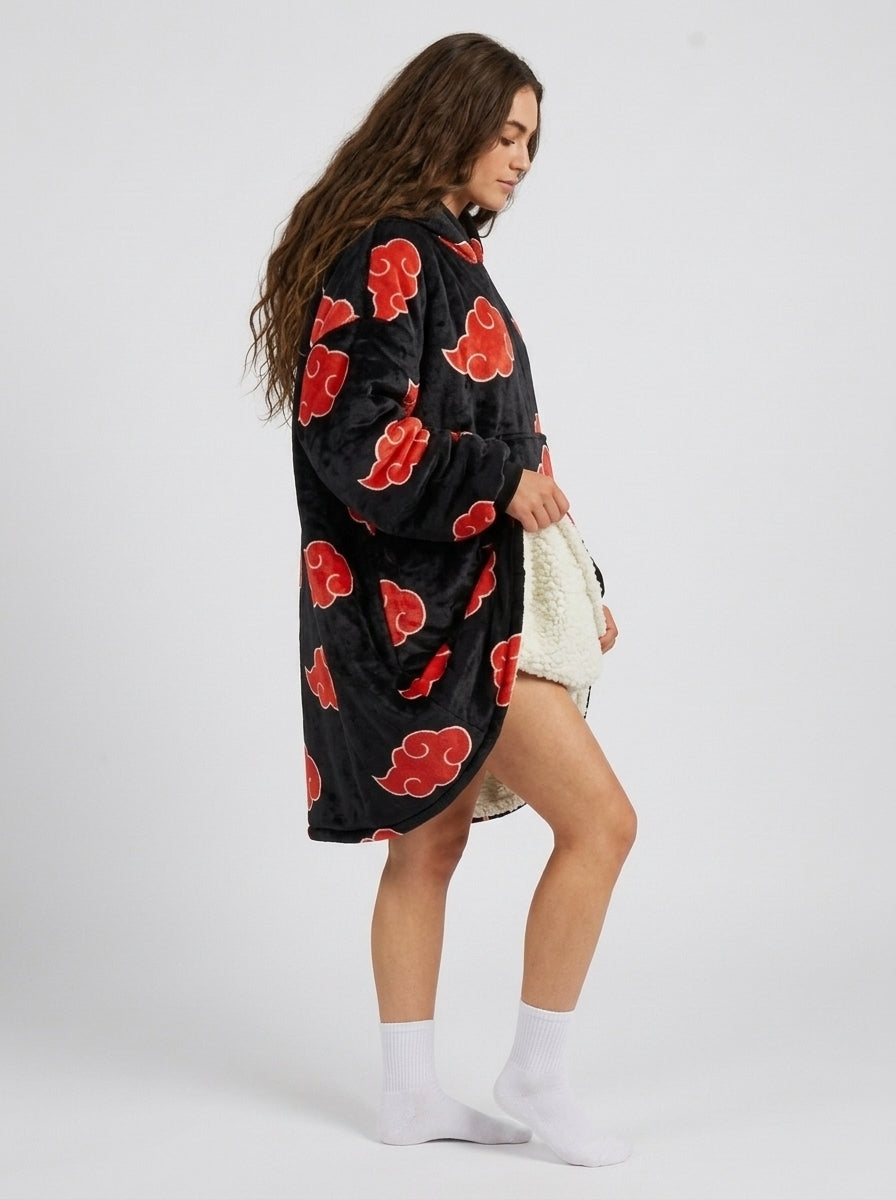 Black fleece blanket hoodie with red cloud pattern on model, three quarter side view