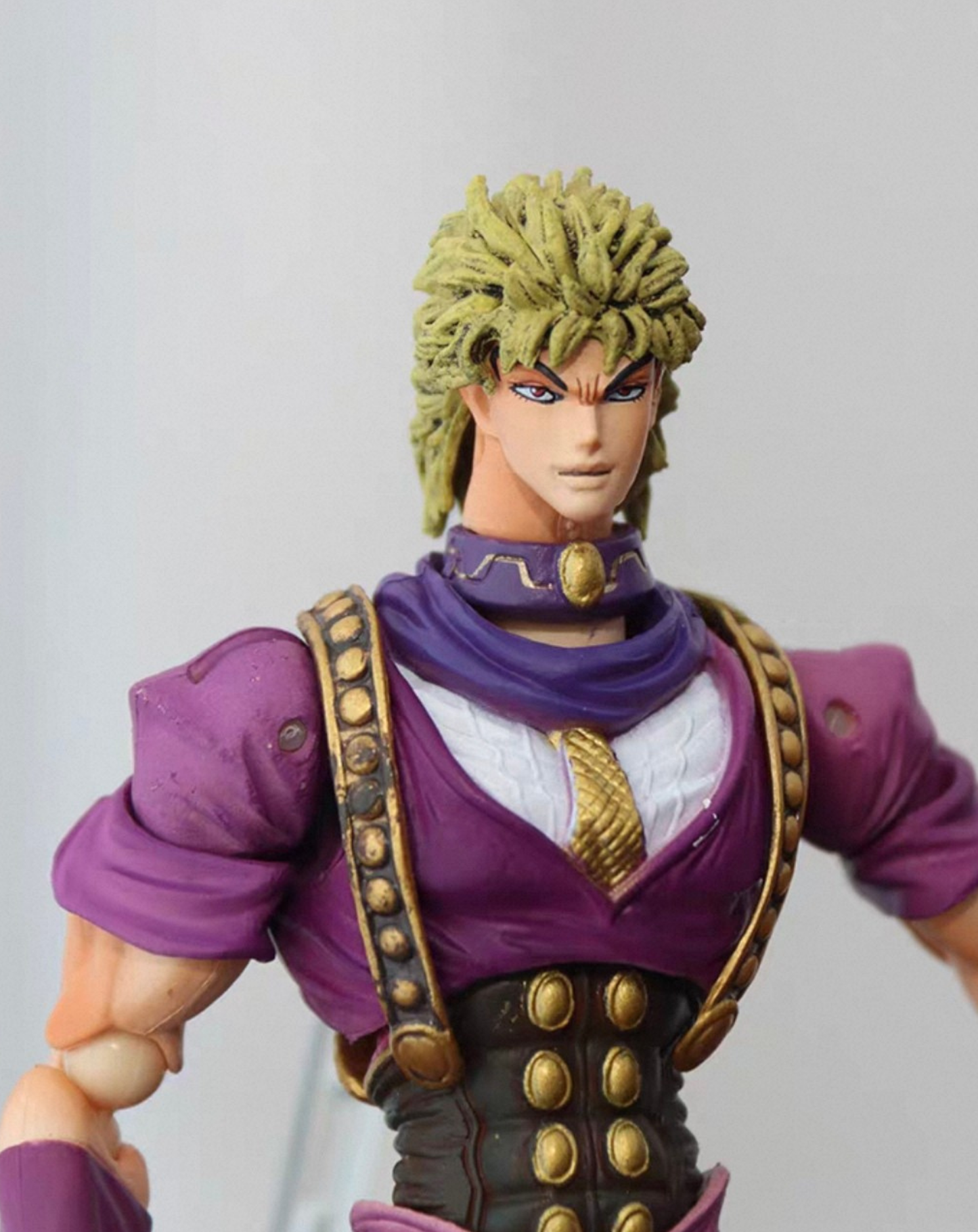 Dio Brando anime figure close-up, upper body detail of the scarf, blond hair and purple costume sculpt on the JoJo collectible statue