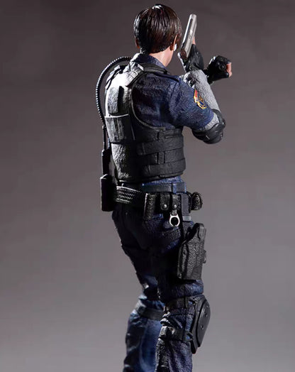 A collectible action figure oLeon Kenedy shown from the back and side, holding a silver pistol, wearing a dark blue uniform, black tactical vest, and dark pants against a gray studio background.