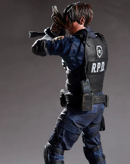 A detailed action figure of Leon Kennedy from Resident Evil, shown from a dynamic three-quarters back view. The figure is wearing a dark blue uniform, a black tactical vest with 'R.