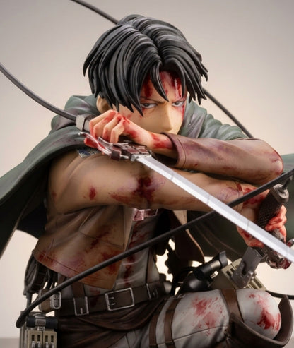 Attack on Titan anime figure of Levi Ackerman in a crouched combat pose, holding a sword, with blood splatters on his face, arms, and clothing against a plain light gray background.