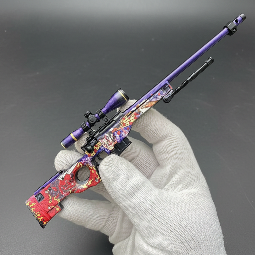Hand holding Mini AWP Oni Taiji CS2 skin replica — small metal collectible desk piece, black background, front angle view