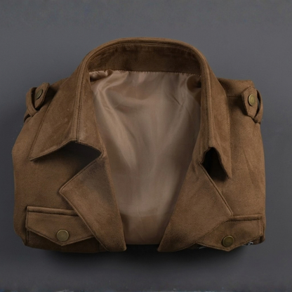 Inside lining and shoulder straps of brown cropped cosplay jacket laid flat, top down detail view