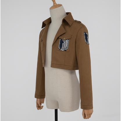 Brown cropped cosplay jacket with collar, flap pockets and wings emblem chest patch, angled front view
