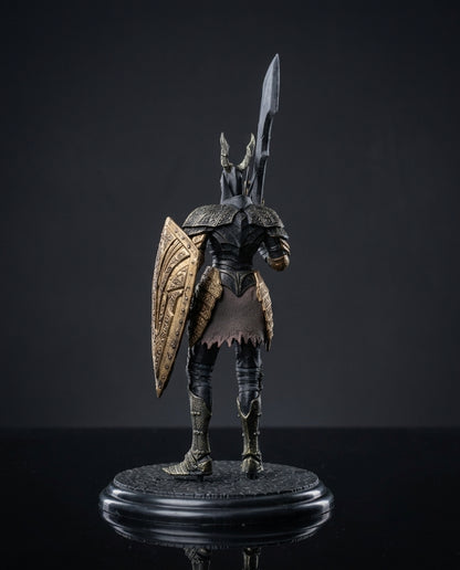 A detailed collectible figurine of Black Knight Full Body Statue Pose shown from the back, wearing dark metallic armor with gold accents, holding a shield and a tall sword, standing on a round black base against a dark studio background.