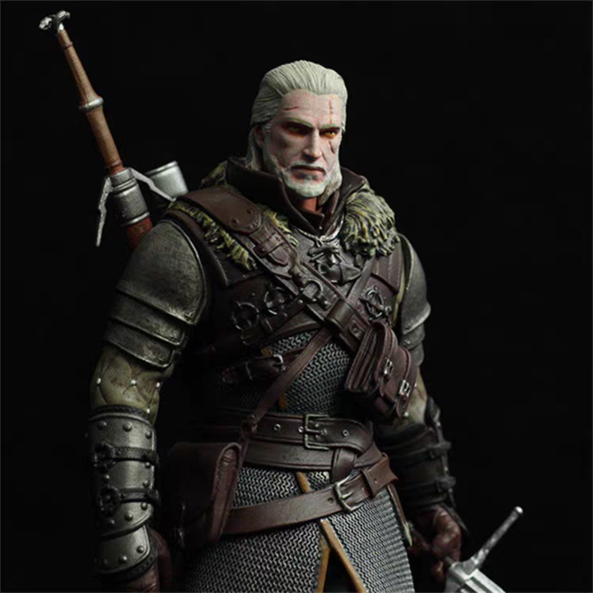 A highly detailed collectible action figure of Geralt of Rivia from The Witcher, featuring his signature white hair, weathered armor, leather straps, and a sword hilt on his back, set against a solid black background.