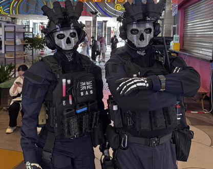 Two cosplayers wearing Ghost skull masks at convention floor, full MW2 operator loadout