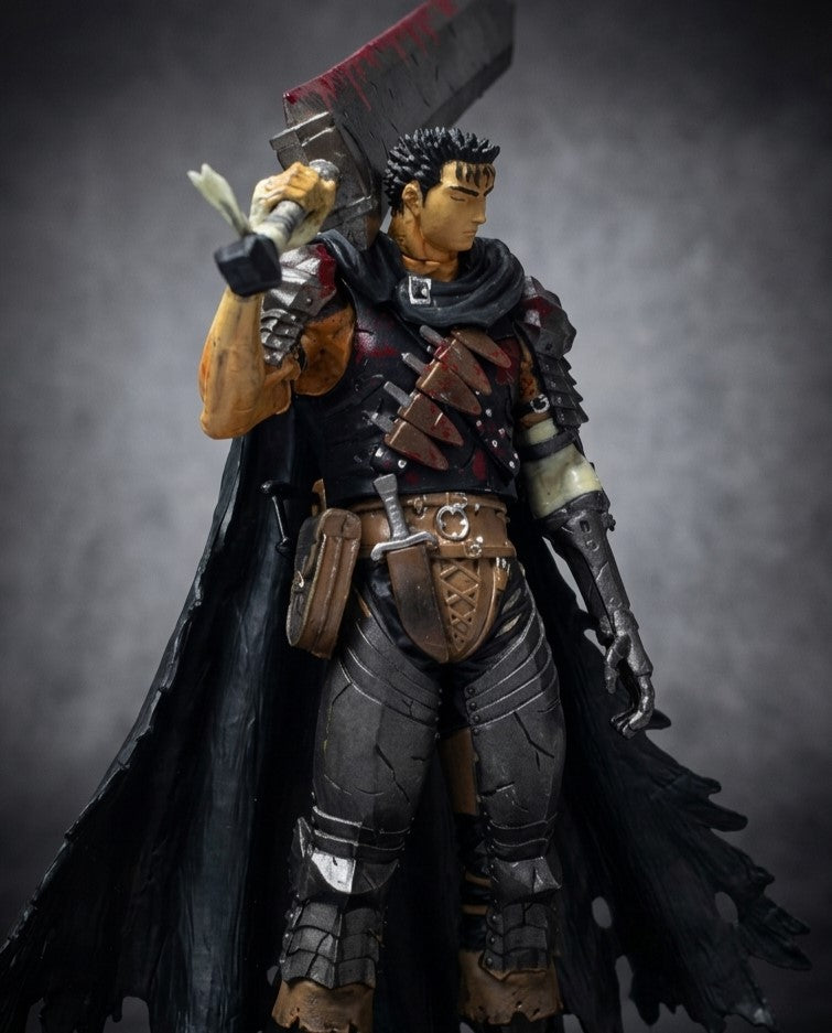 Berserk Guts collectible statue at a three-quarter angle, showing the battle-worn armor, tattered cloak and massive raised greatsword