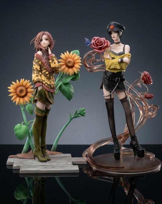 Nana Osaki Hachi Komatsu Figurine Duo View. Two figurines posed together on a dark reflective studio background. The left figure has pink hair, wears a yellow patterned sweater and green skirt, and stands beside large sunflowers.