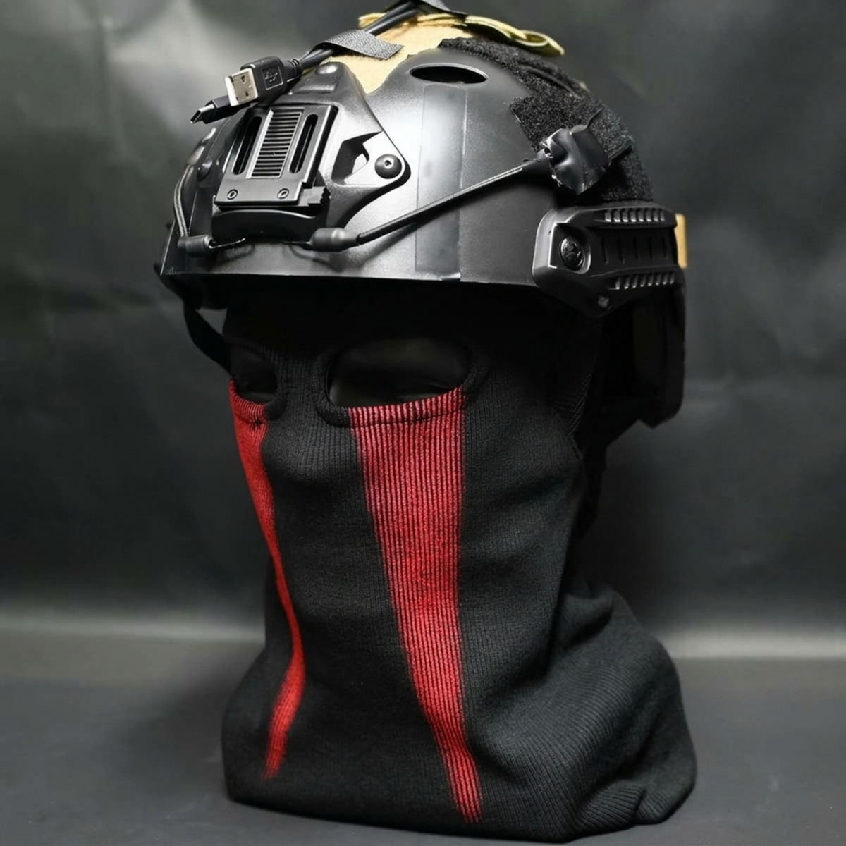 Konig cosplay helmet with black balaclava face mask featuring red stripe accents, front view on mannequin