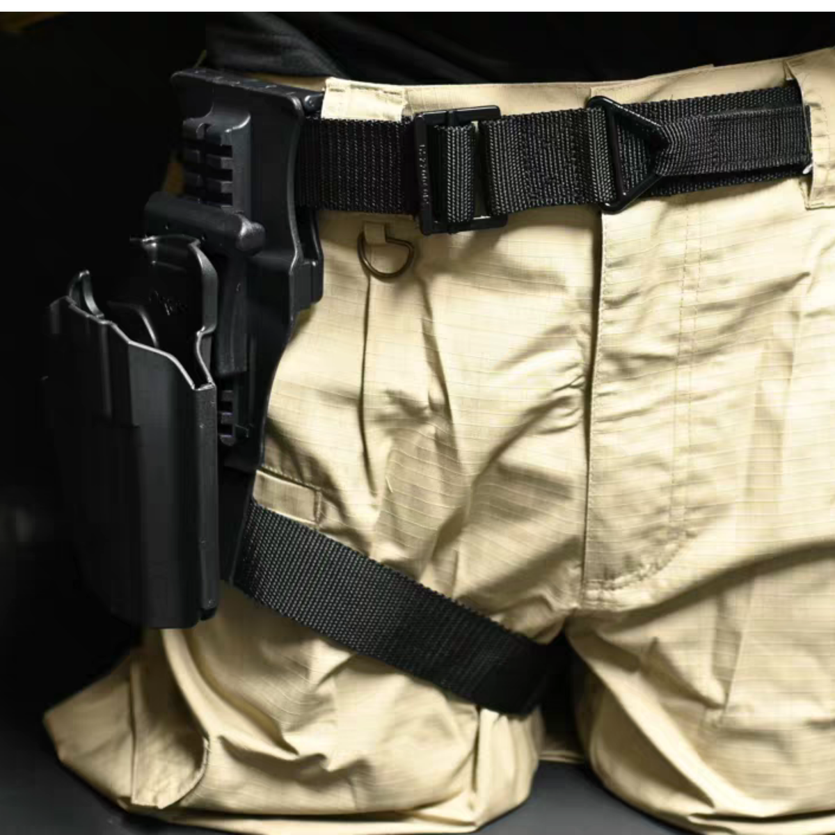 Close up of tan tactical cargo pants with black belt and leg holster worn with Konig cosplay set, side view