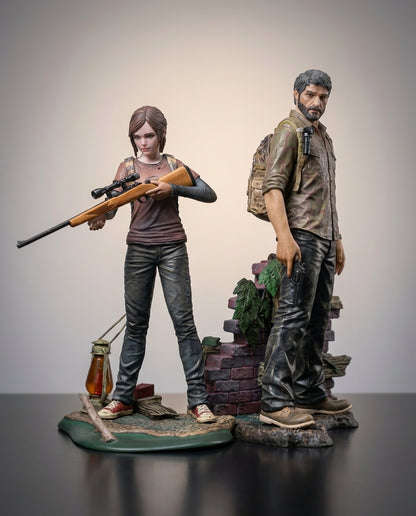 The Last of Us Joel and Ellie figures together, full front view of the 19cm collectible statues on their scenic bases