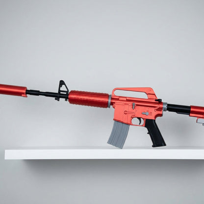 Life size M4A1-S Rat Rod CS2 replica displayed on white wall shelf — full 95cm length visible, red metallic finish with grey magazine, clean studio background, side profile view