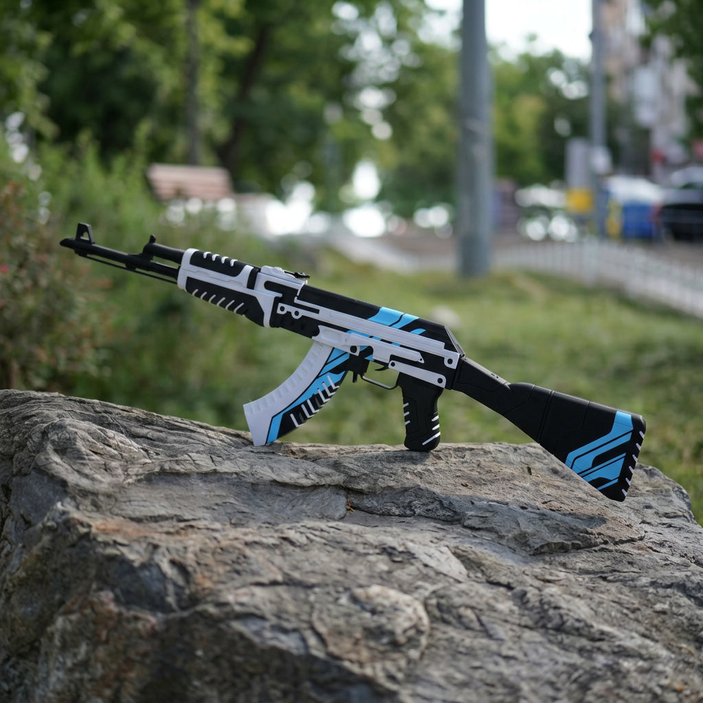 Life size 87cm AK47 Vulcan CS2 replica held in hand outdoors — white and blue geometric skin detail, grass background, front angle view