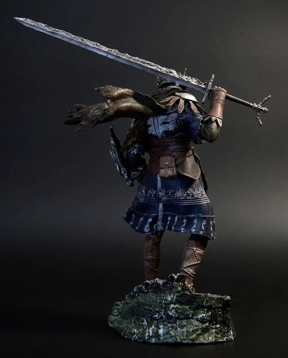 Back view of the Wylder figurine showing the flowing cloth cape, back armor plating, and greatsword strap detailing sculpted for full 360-degree display accuracy