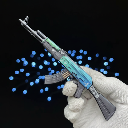 Gloved hand holding CS2 AK47 Ice Colaled mini replica vertically, showcasing vibrant teal and blue gradient skin from close up