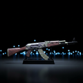 CS2 AK47 Jaguar mini replica on display stand, dark body with green camo and orange print pattern under blue studio lighting