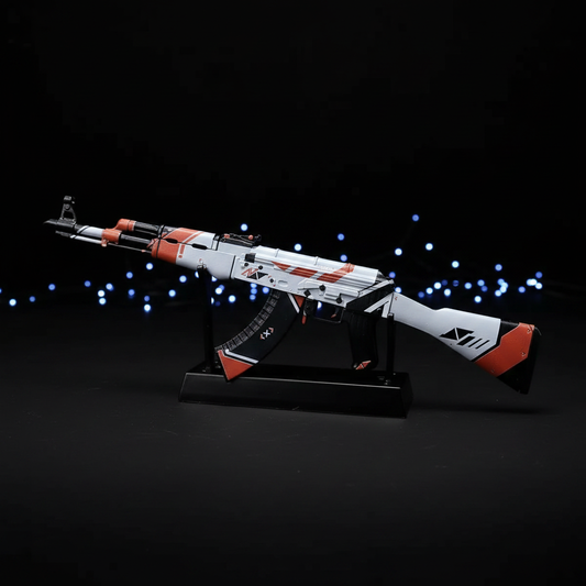 CS2 AK47 Asiimov mini replica on display stand, iconic white black and orange futuristic sci-fi skin under dramatic studio lighting
