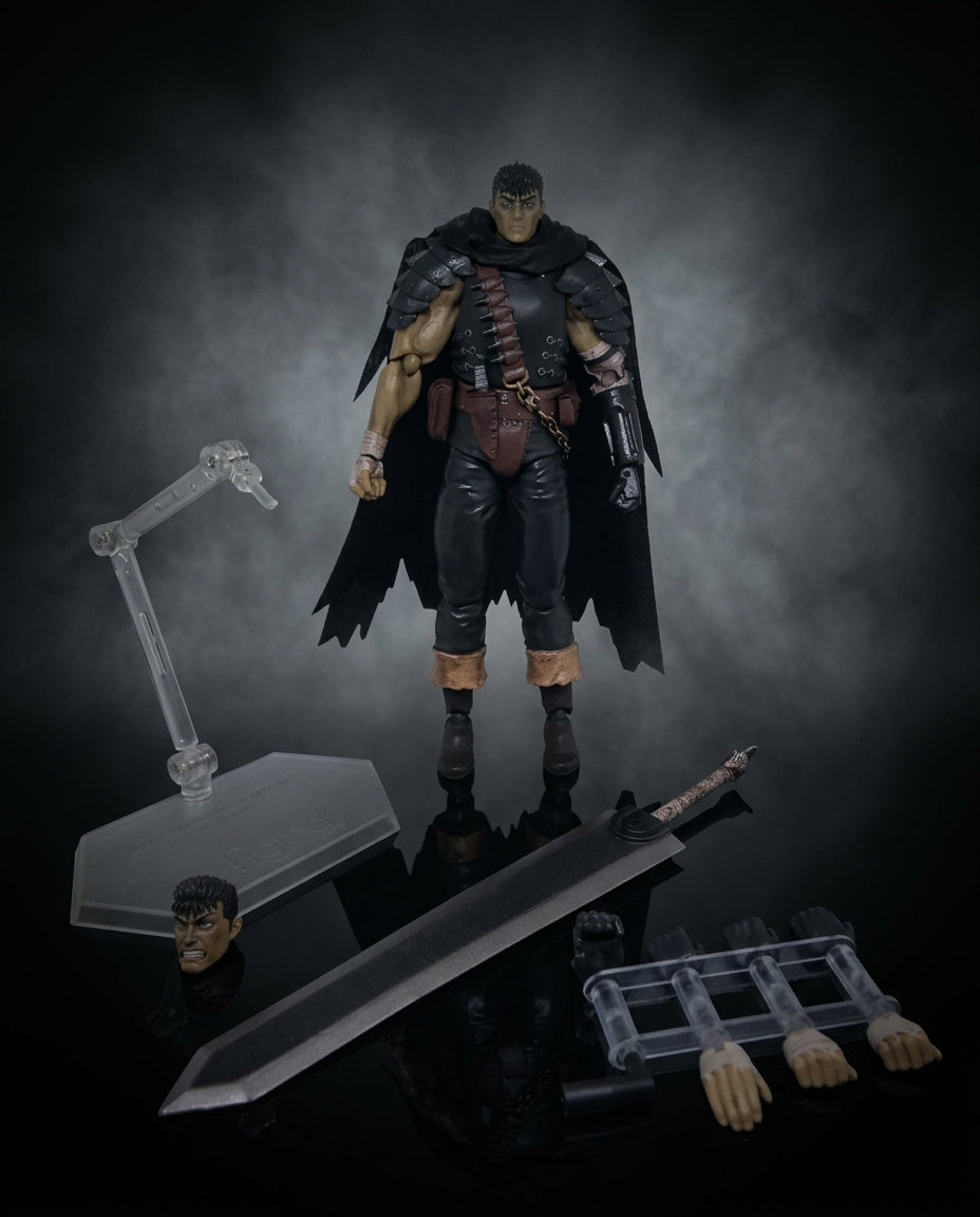 Guts Berserk statue shown in side profile with the included round display base and small accessories arranged on the dark surface