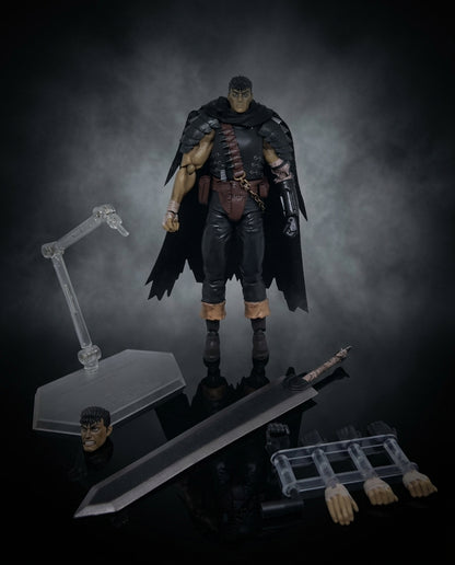Guts Berserk statue shown in side profile with the included round display base and small accessories arranged on the dark surface