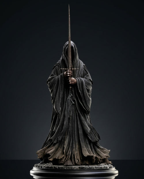 Ringwraith of Mordor figurine side profile holding a drawn sword, flowing hooded robe cast in dark weathered texture against a black background