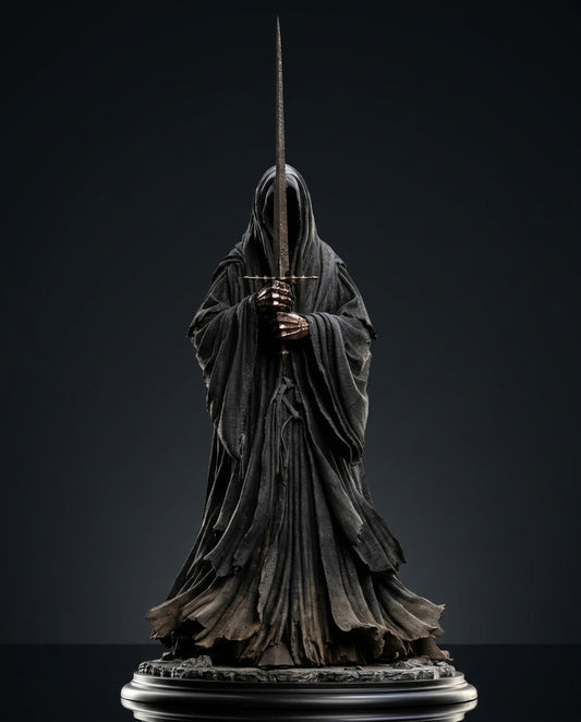 Ringwraith of Mordor figurine side profile holding a drawn sword, flowing hooded robe cast in dark weathered texture against a black background