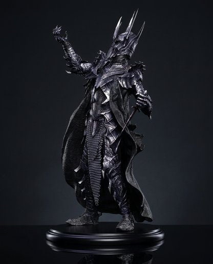 Sauron statue captured with raised clawed hands in a commanding, menacing pose against a dark backdrop