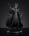 Full front view of the Sauron statue showing the flowing dark cloak and towering armored silhouette